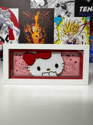 Light box decorativo Hello Kitty in cornice bianca, sfondo rosa con disegni kawaii.
