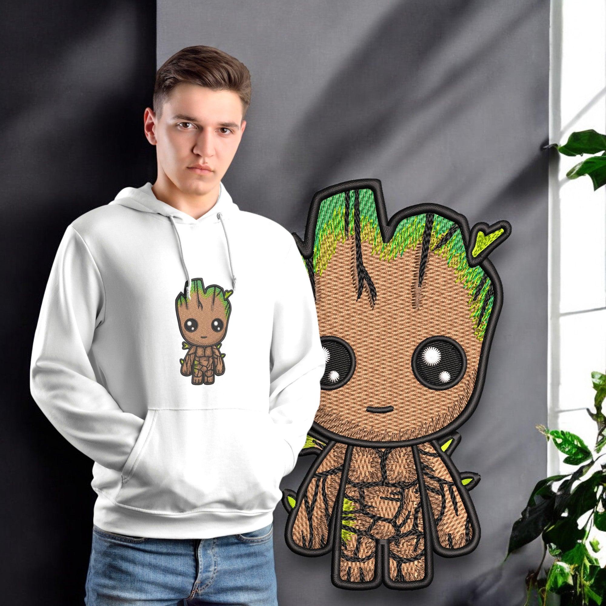 Ragazzo con felpa bianca ricamata con personaggio Baby Groot, design stile anime, vicino a poster.