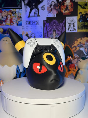 Supporto per controller a forma di Umbreon Pokémon, ambientato su sfondo anime colorato.