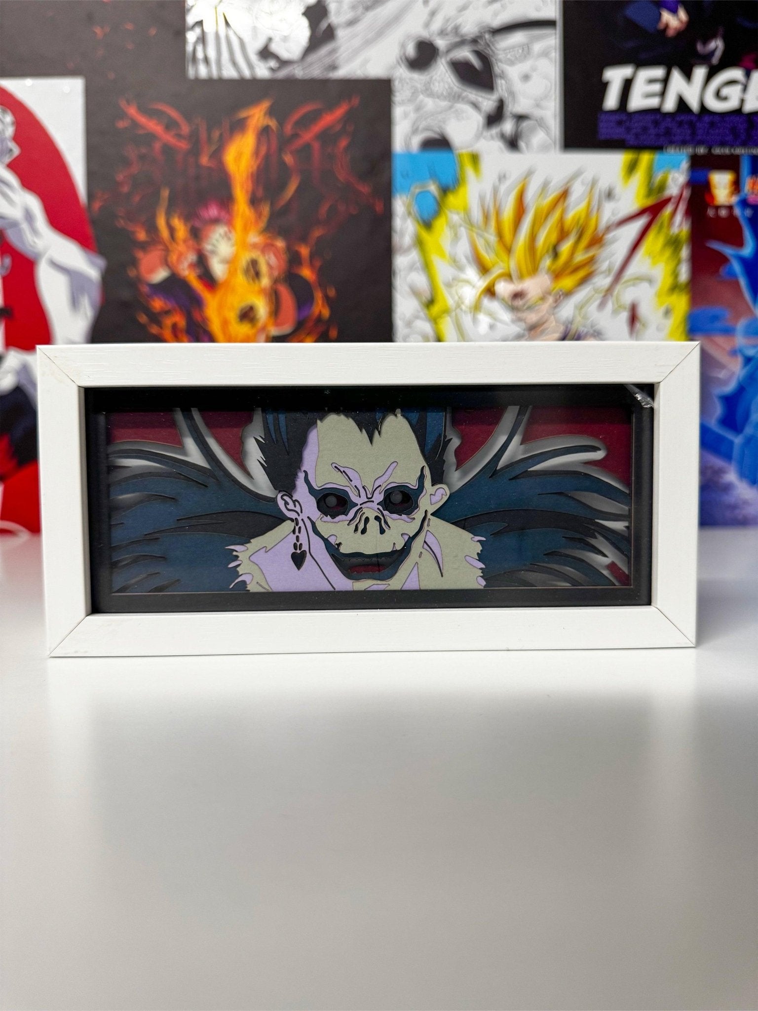 Light box decorativa con Ryuk di Death Note in primo piano, cornice bianca, sfondo anime.
