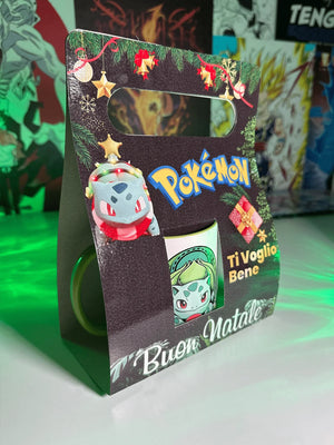 Confezione regalo natalizia tazza Pokémon Bulbasaur con scritta Buon Natale e decorazioni festive.